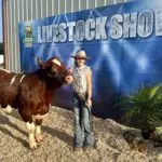 Grey Mixon with her 2024 steer Dion, raised for the Henry County Youth Livestock Show in Paris, TN