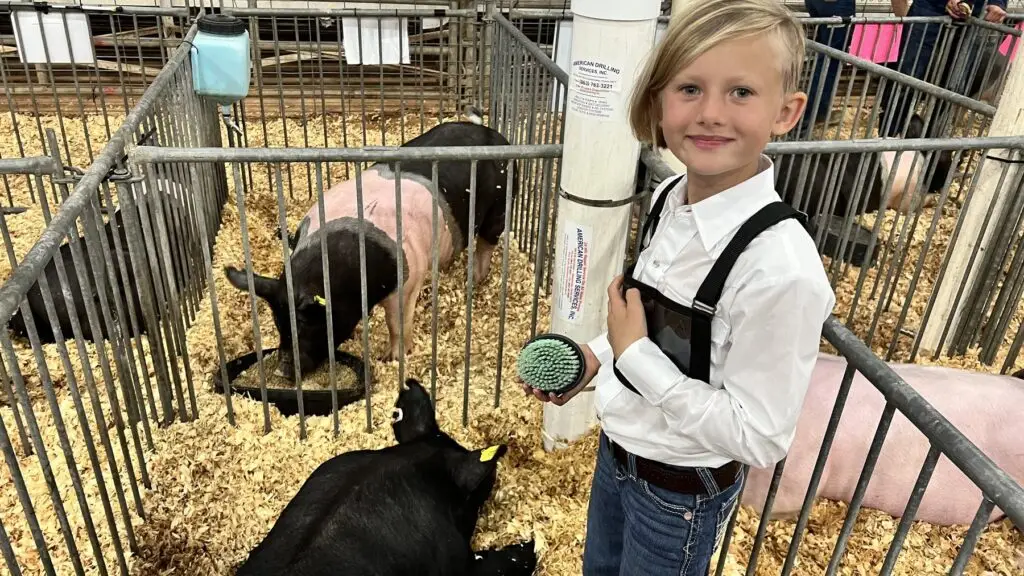Grey Mixon with her hog Marshmallow at the Okeechobee Youth Livestock Show, Okeechobee, FL